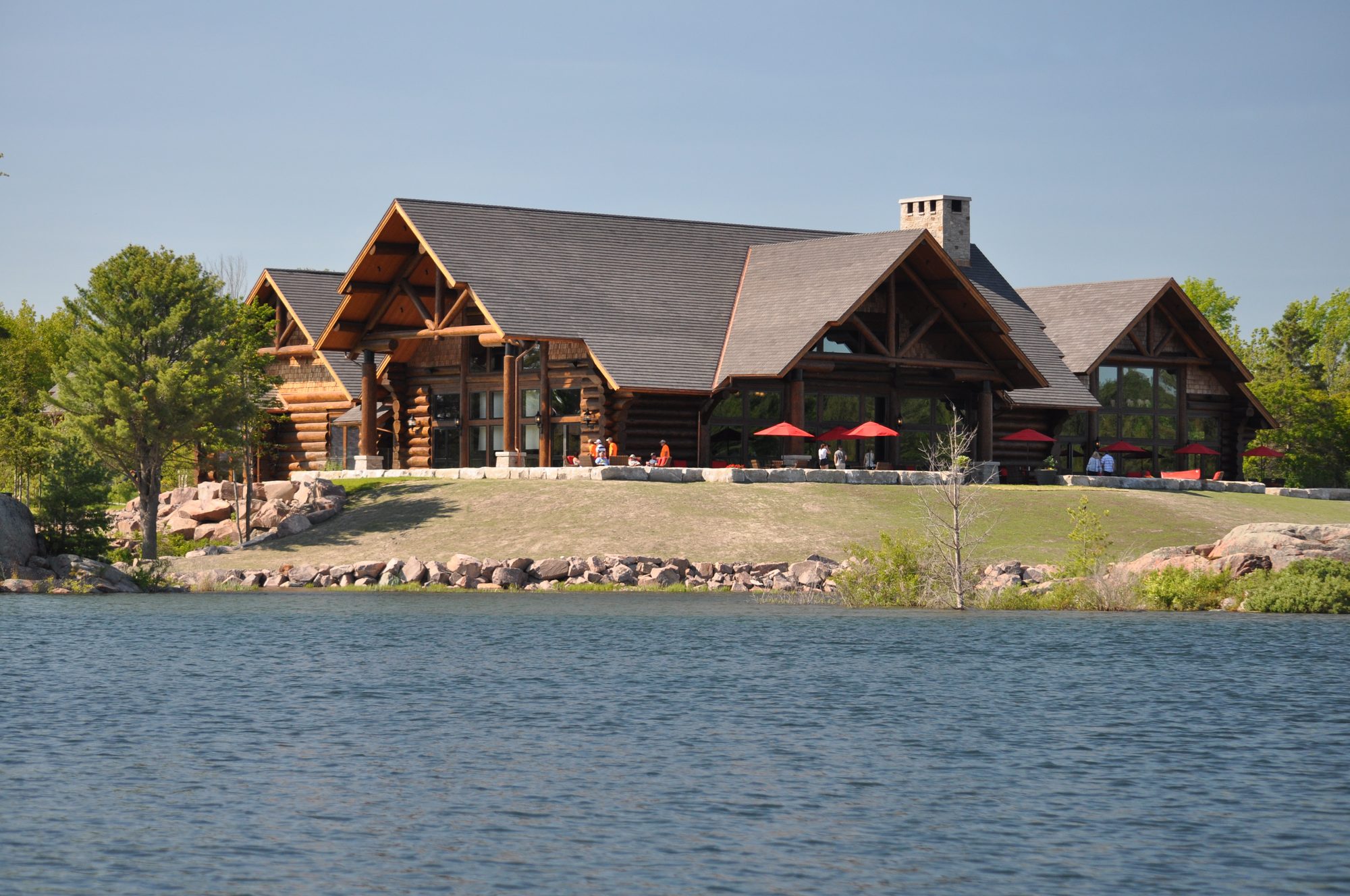 Canada House from the water — log gables and the waterfront patio