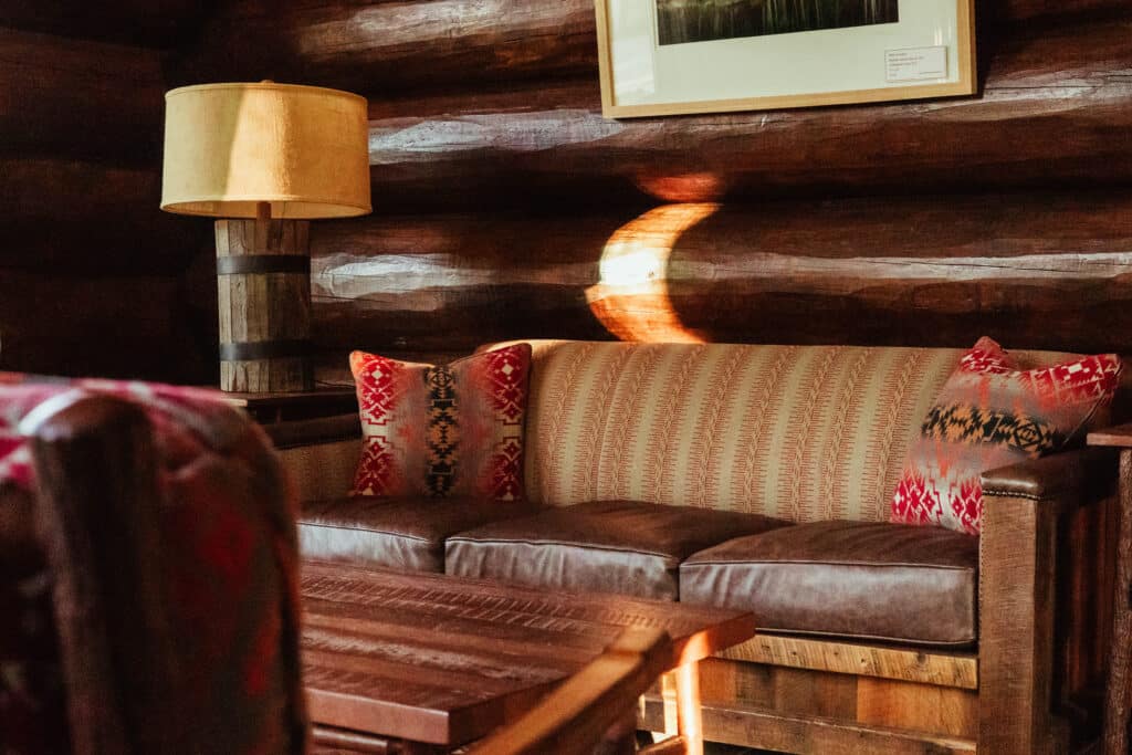 Warm log-walled lounge with leather sofa