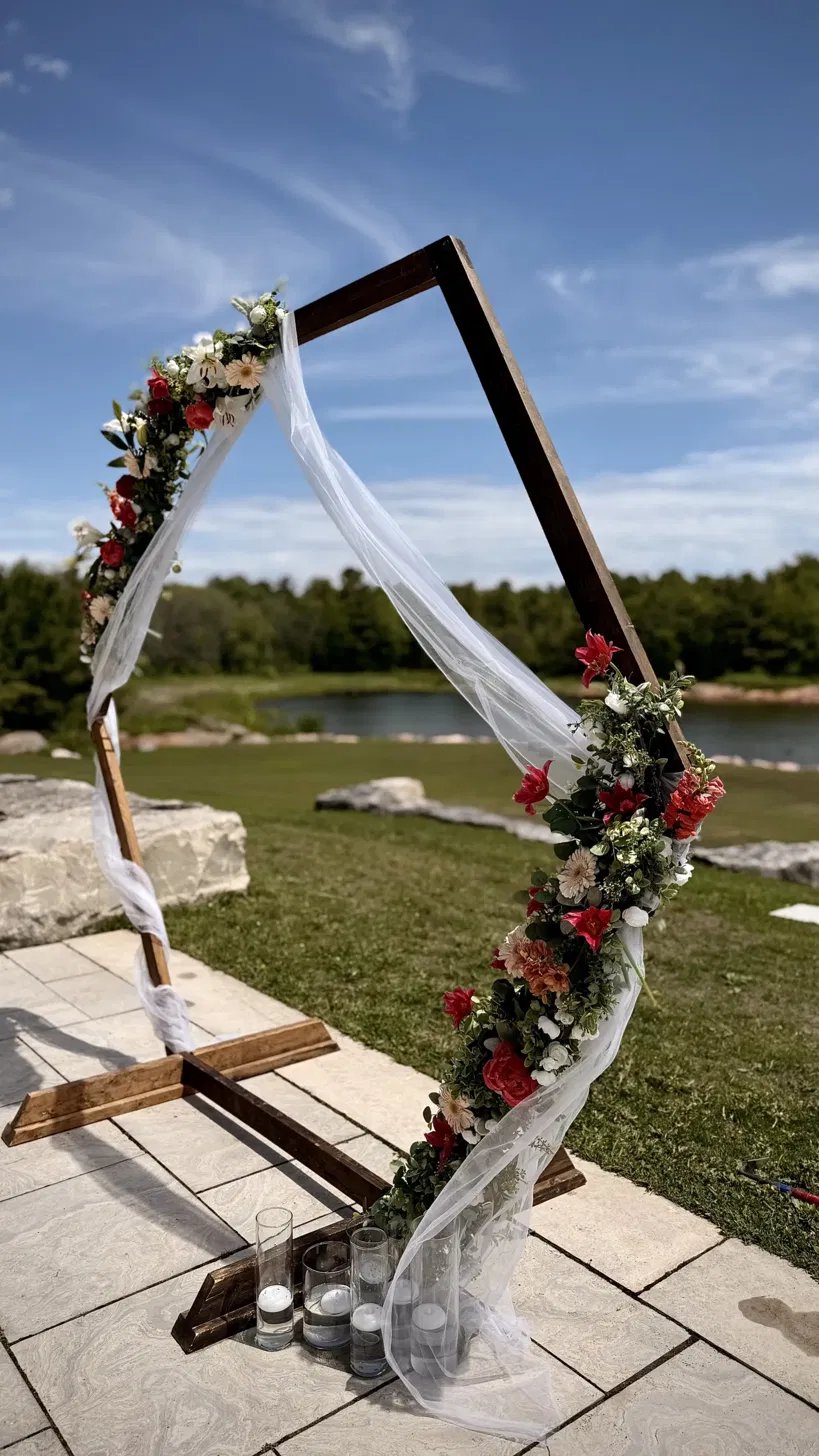 The hexagonal floral arch on the terrace above the water