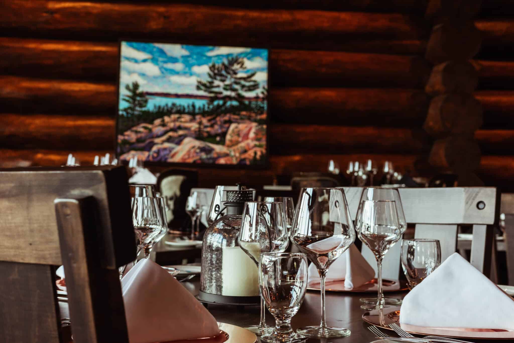 The Ranch House set for dinner beneath log walls
