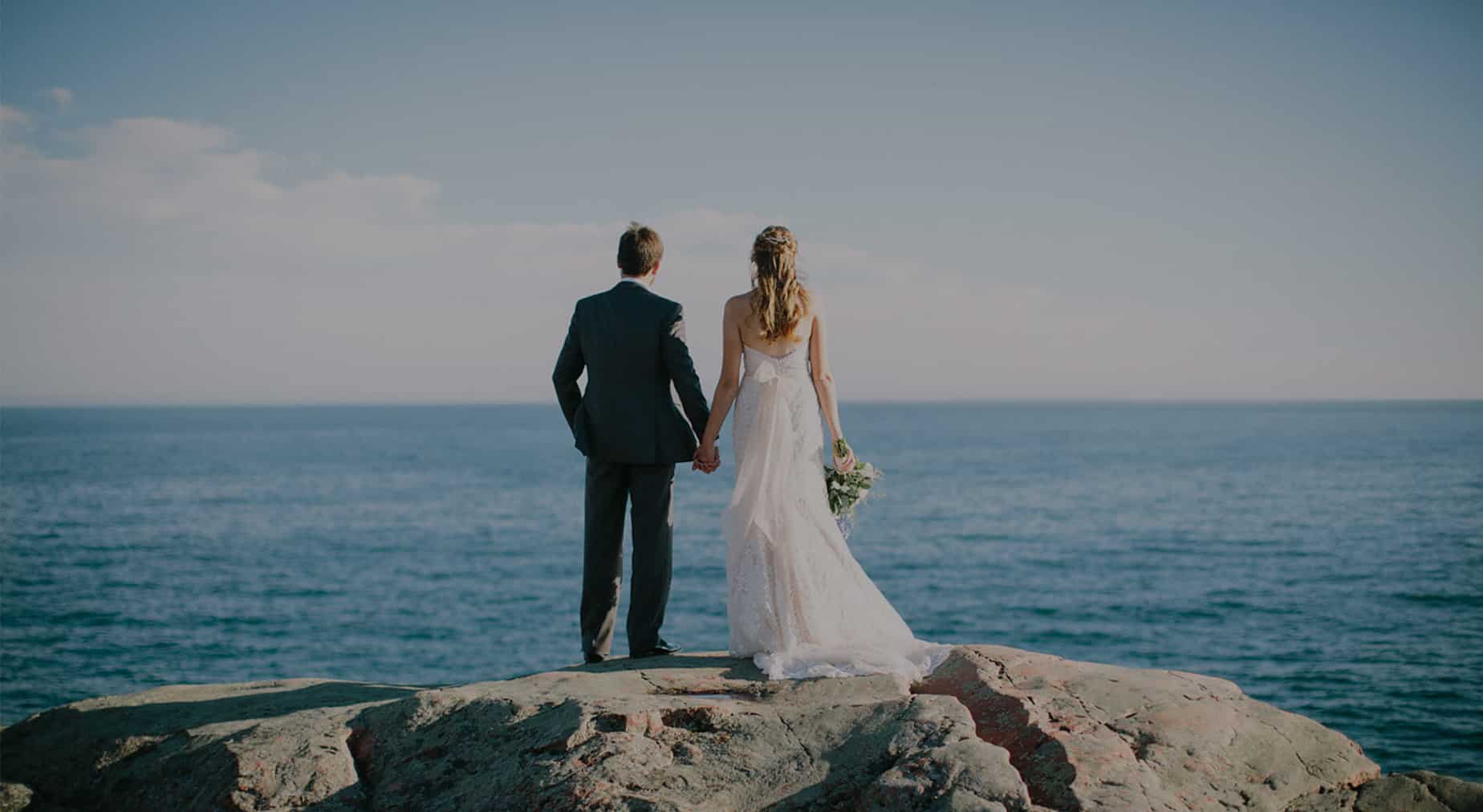 Bride and groom on the granite above the bay